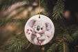 a christmas ornament with a koala holding a candy cane
