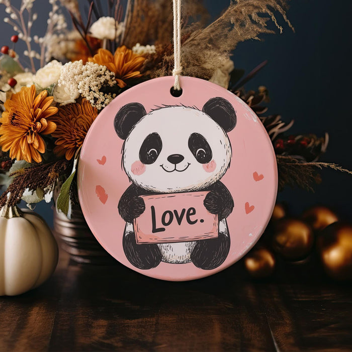 a ceramic ornament with a panda holding a love sign