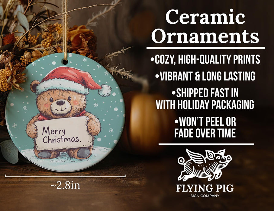 a ceramic ornament with a teddy bear holding a sign