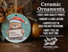 a ceramic ornament with a teddy bear holding a sign