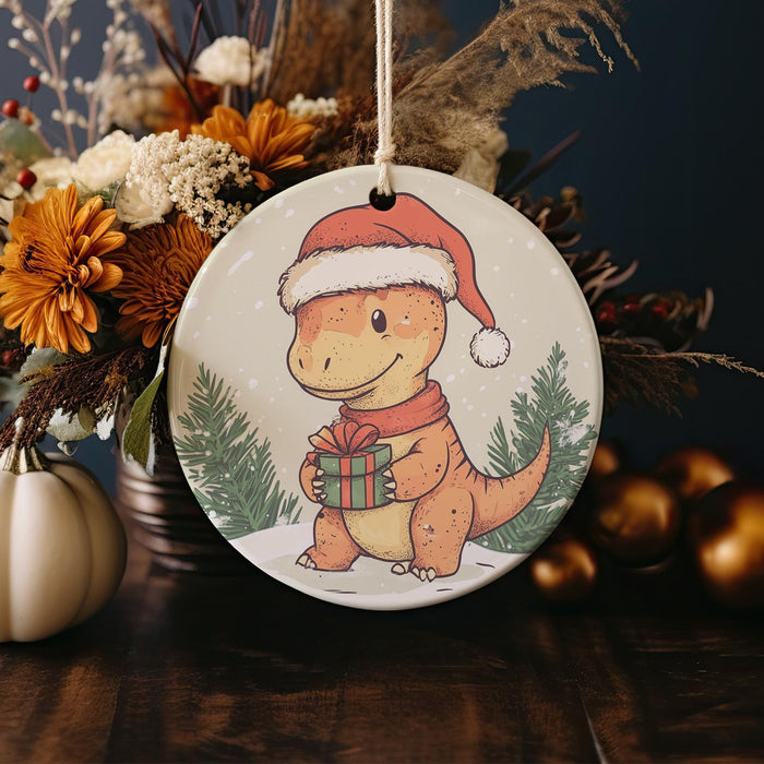 a christmas ornament with a dinosaur holding a present