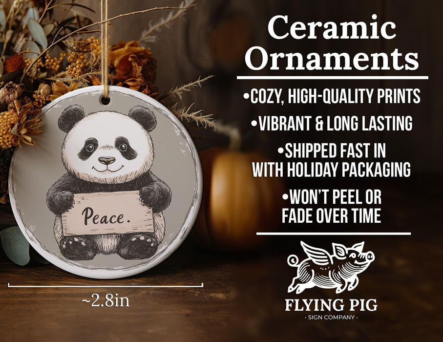 a ceramic ornament with a panda holding a sign