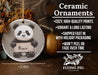 a ceramic ornament with a panda holding a sign