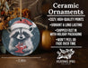 a ceramic ornament with a raccoon holding a present