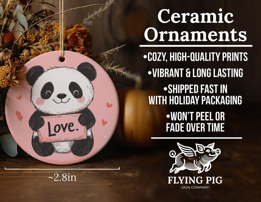 a ceramic ornament with a panda holding a love sign