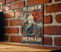 there is a picture of a mermaid on the wall
