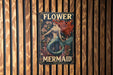 a sign on a wooden wall that says flower mermaid
