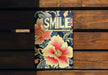 a smile book sitting on top of a wooden bench