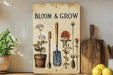 a wooden sign with flowers and gardening utensils