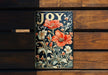 a wooden bench with a painting of flowers on it