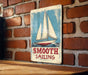a sign on a brick wall that says smooth sailing
