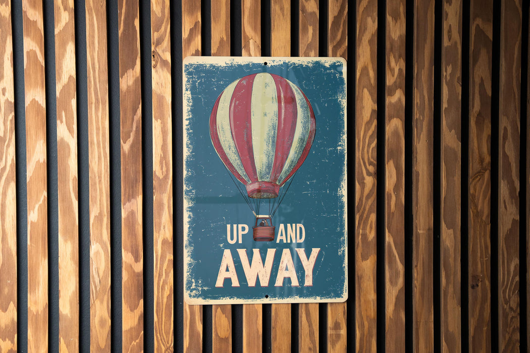 a sign that says up and away on a wooden wall