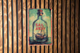 a picture of a boat in a bottle on a wall