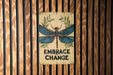 a sign on a wooden wall that says embrace change