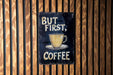 a sign that says but first, coffee on a wooden wall