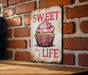 a sign on a brick wall that says sweet life