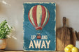 a painting of a hot air balloon with the words up and away