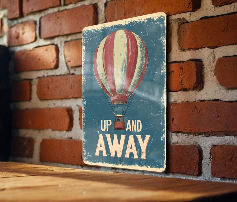 a sign that says up and away on a brick wall