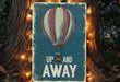 a sign that says up and away with a hot air balloon