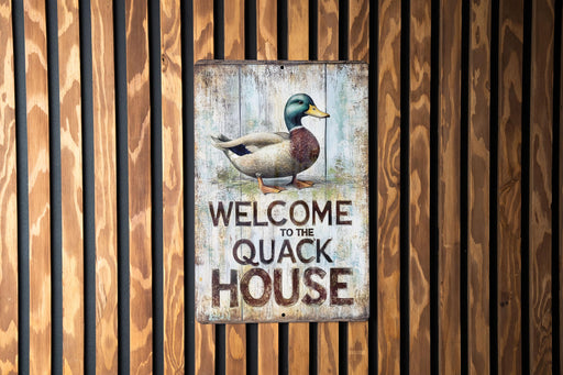 a sign on a wooden wall that says welcome to the quack house