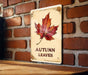 a sign on a brick wall that says autumn leaves
