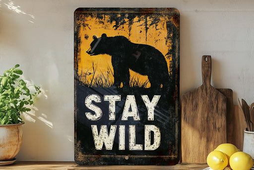a sign that says stay wild on a shelf