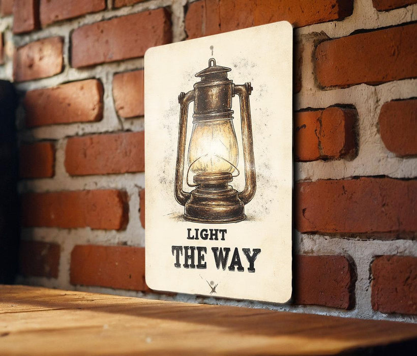a light the way sign on a brick wall
