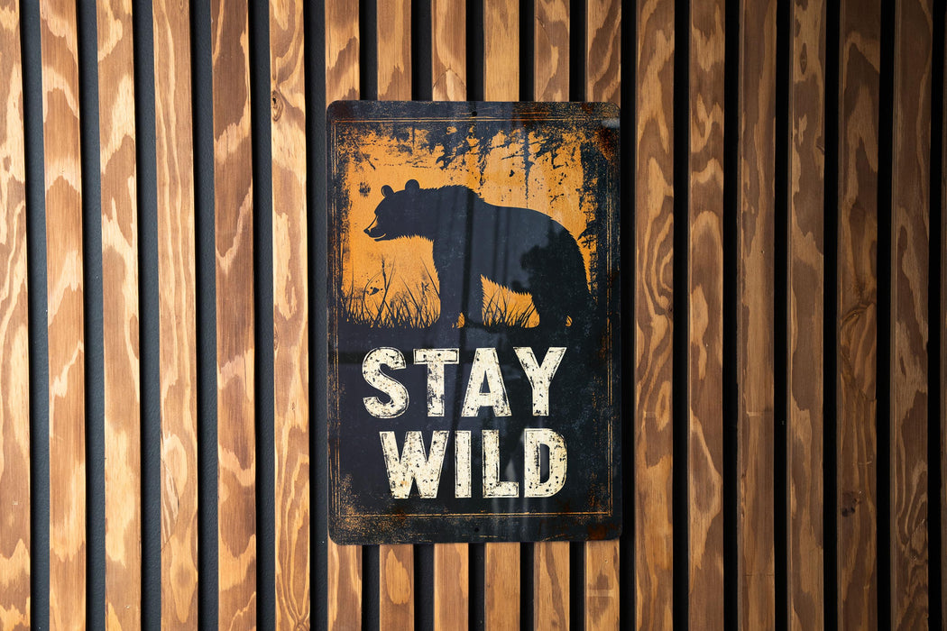 a sign on a wooden wall that says stay wild
