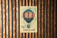 a picture of a hot air balloon on a wooden wall