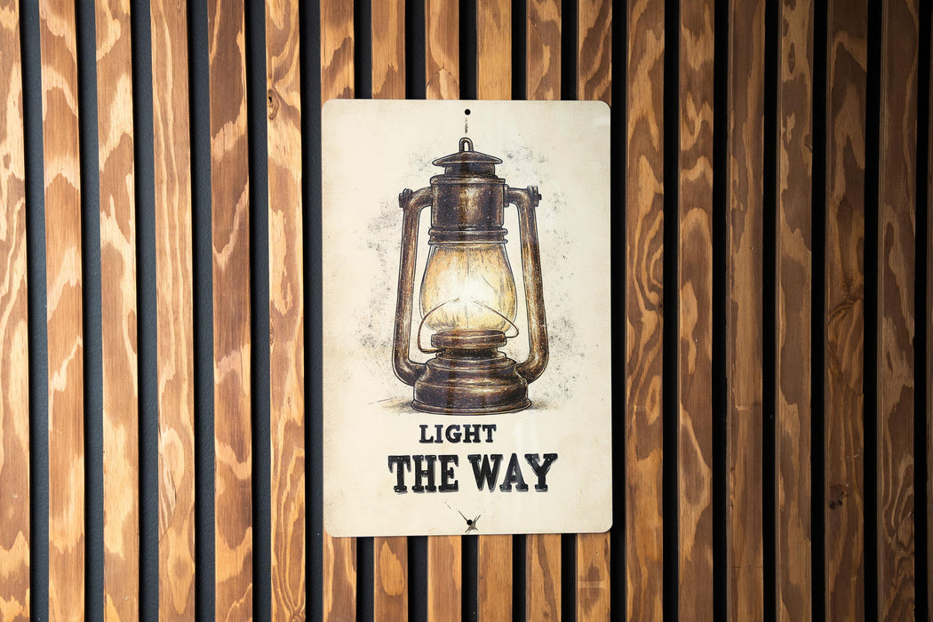 a light the way sign on a wooden wall