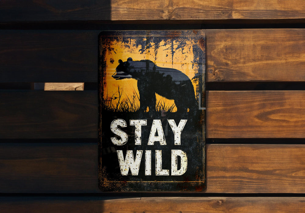 a sign that says stay wild on a wooden wall