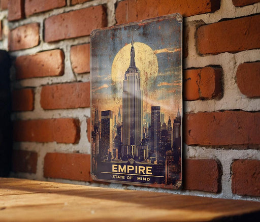 a picture of the empire state of mind hanging on a brick wall