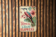 a sign on a wooden wall that says tropical crane flowers