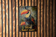 a picture of a toucan bird on a wooden wall
