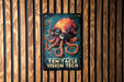 a sign with an octopus on it on a wooden wall
