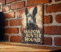 a sign on a brick wall that says shadow hunter hound