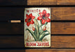 a sign on a wooden bench that says winter bloom savers