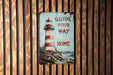 a sign on a wooden wall that says guide your way home