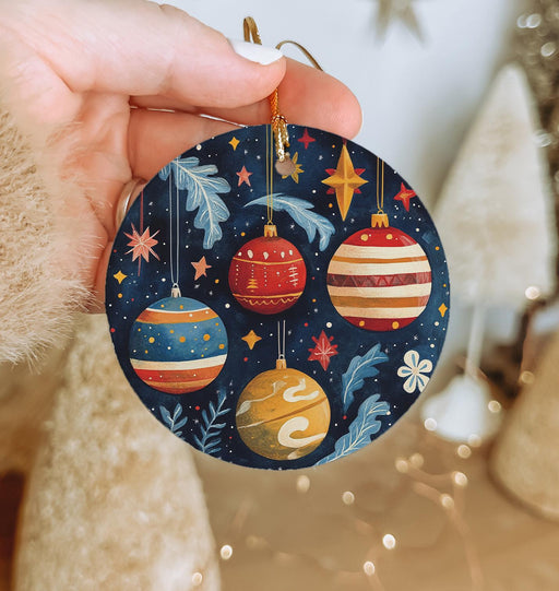a person holding a christmas ornament in their hand