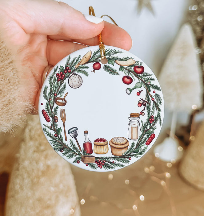 a person holding a christmas ornament in their hand