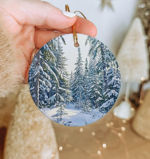 a person holding a christmas ornament in their hand