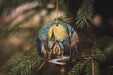 a christmas ornament hanging from a christmas tree