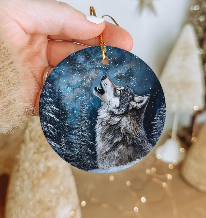 a person holding a ornament with a wolf on it