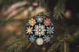 a snowflake ornament hanging from a christmas tree