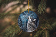 a wolf ornament hanging from a christmas tree
