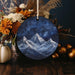 a blue ornament with a mountain scene on it