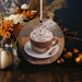 a cup of hot chocolate with whipped cream on a plate