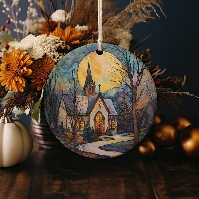 a ceramic ornament with a painting of a church
