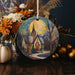 a ceramic ornament with a painting of a church