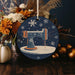 a christmas ornament with a sewing machine on it